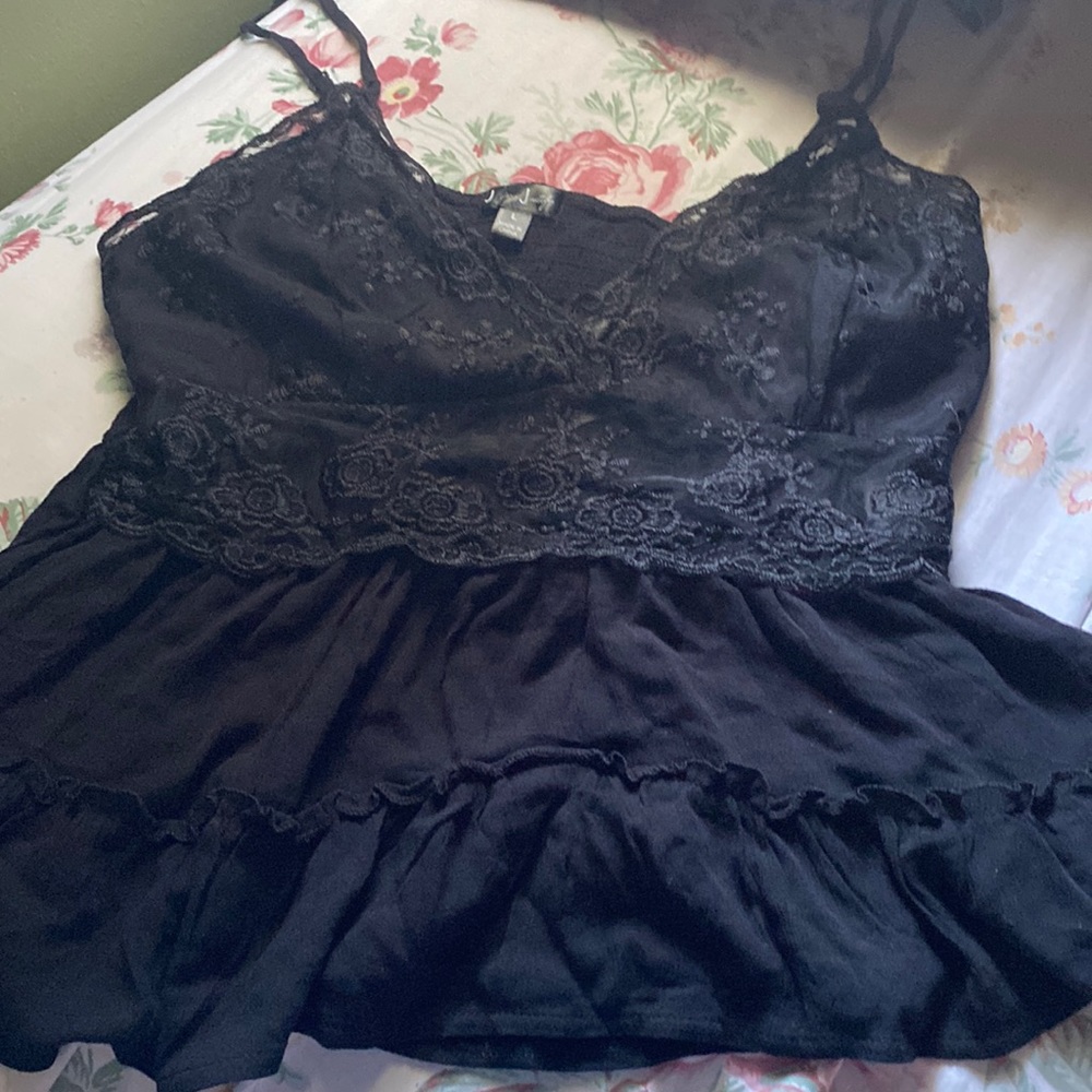 Top from j for justice, black and lace, and is flowing at the bottom.